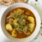A bowl full of meat and potato stew