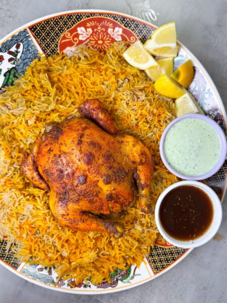 Whole chicken is marinated and baked with sajji masala, then served with fragrant sajji rice
